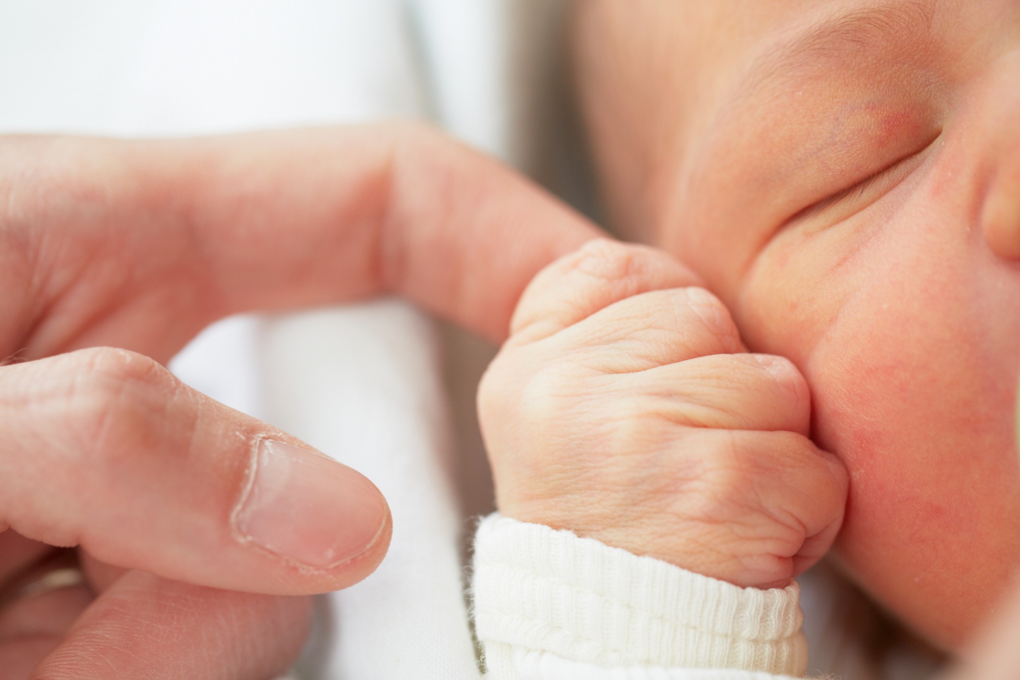 baby_face_hand_holding_finger