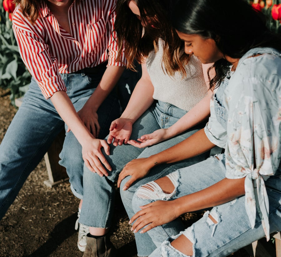 Women praying with one another