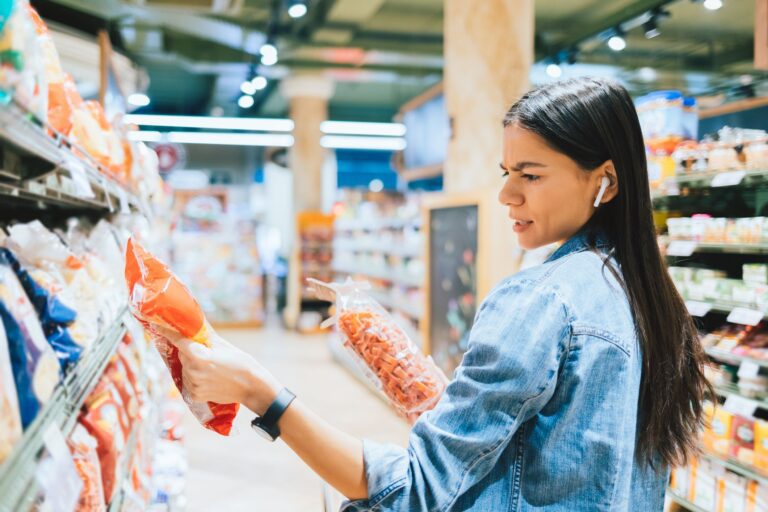 woman searching label on product in supermarket
