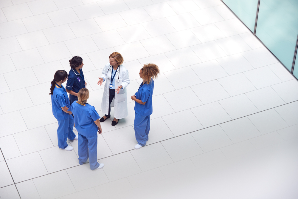 overhead view of female physician doctor with nurses
